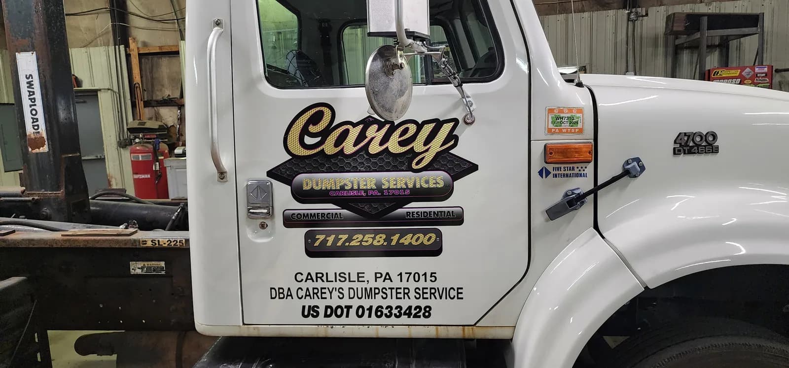 Carey Dumpster Services work truck with door lettering