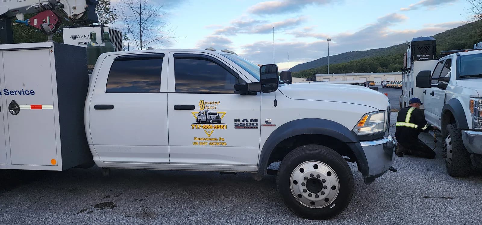 White commercial service truck with custom graphics