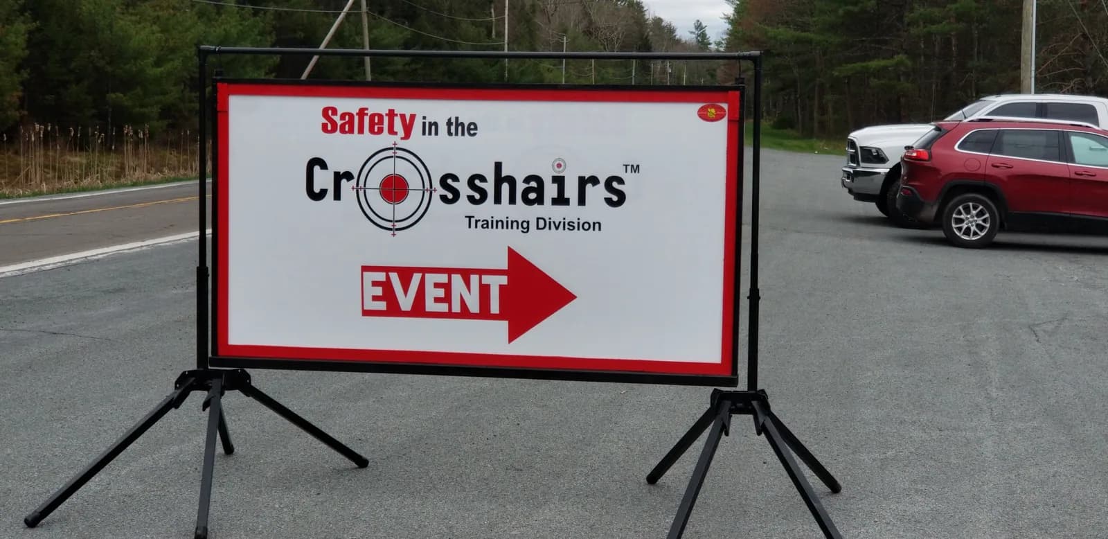 Crosshairs event directional sign on a display stand
