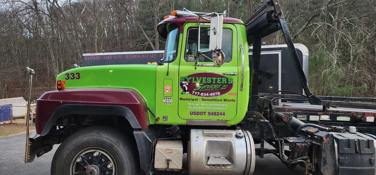 Green commercial fleet truck with finished business graphics