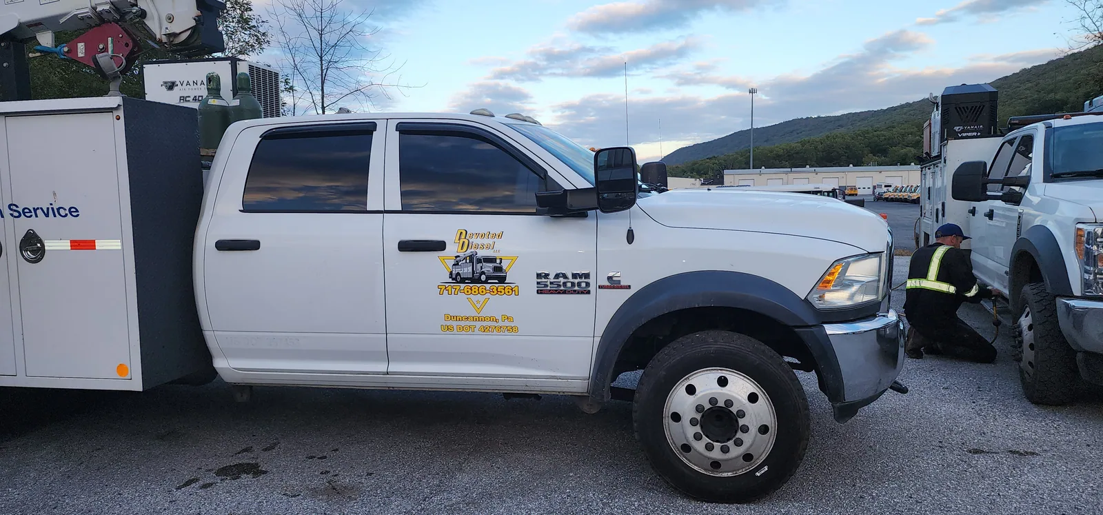 Commercial service truck with custom business graphics on the doors and body